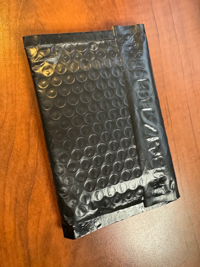 Bubble mailer is folded over in half, and sealed to itself.